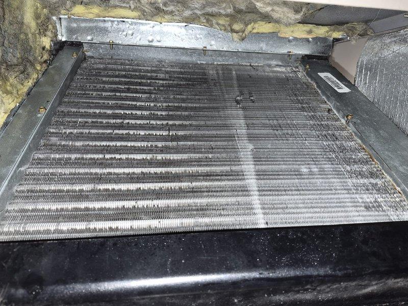 Performed comprehensive evaporator coil and blower wheel cleaning on residential HVAC system. Removed heavily soiled squirrel cage blower assembly showing significant dirt accumulation and discoloration across fins and blades. Cleaned evaporator coil unit with multiple rows of aluminum fins that had accumulated dust and debris, affecting system efficiency. Both components were thoroughly cleaned and reinstalled to restore proper airflow and heat transfer capacity.