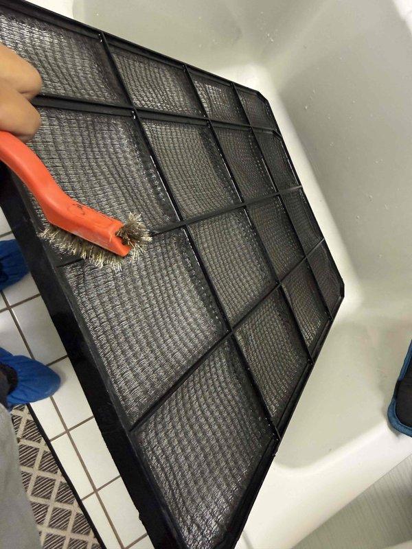 Performed spring clean and check maintenance on two air conditioning systems per comfort plan agreement. Completed comprehensive system inspections including temperature readings at supply registers, which measured 51.62°F indicating proper cooling performance. Cleaned reusable air filter by removing accumulated dust and debris, scrubbing filter media thoroughly to restore proper airflow. Delivered and noted required replacement filters including 20x25x4 media filter and 16x25x1 standard filter for customer installation. Verified both systems operating within normal parameters with adequate airflow and temperature differential across evaporator coils.