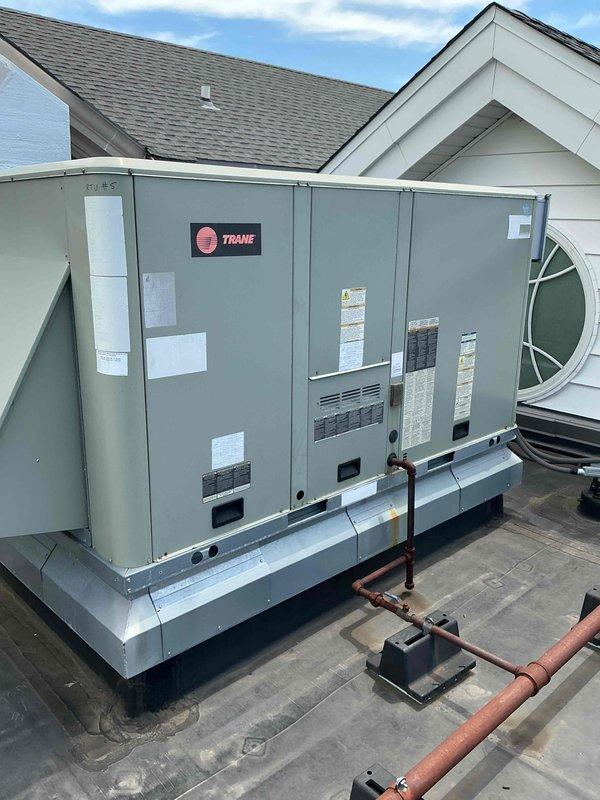 Replaced failed drain pan in rooftop unit RTU5 located on lower level rooftop. Removed damaged component, installed new coil pan, and verified proper drainage function. Collected outstanding balance for completed repair work.