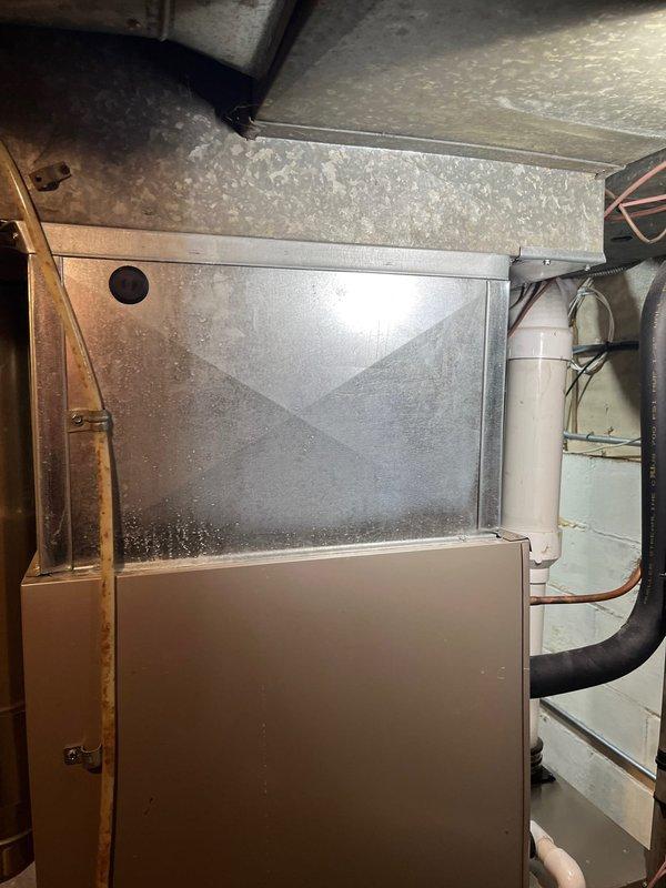 Conducted on-site evaluation for furnace replacement estimate. Existing unit, originally installed 12 years ago, has been non-operational since installation. Documented current equipment configuration including furnace, ductwork connections, and associated mechanical components in basement installation. Assessed clearances, venting system with PVC exhaust, flexible aluminum supply ductwork, and overall system layout to provide comprehensive replacement recommendations.