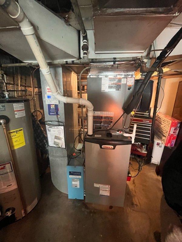 Completed full HVAC system replacement including disconnection and disposal of existing forced air furnace and air conditioning system. Installed new EL297UH090XV36C forced air furnace (Model 26K71) with connections to existing supply/return ductwork, gas line, electrical circuit, and exhaust system. Reclaimed refrigerant from old AC system and installed new EL18KCV-036-230 condensing unit (Model 25U59) on new pad with pea gravel, along with matching evaporator coil. Connected new AC system to existing copper refrigerant lines, evacuated system, and charged with R454B refrigerant. Installed Aprilaire Model 720A high-capacity powered humidifier designed for homes up to 4,200 square feet. Added surge protector and new thermostat to complete system integration. Performed startup procedures, system testing, adjustments, and comprehensive safety inspection on all equipment to verify proper operation. All components covered by 10-year parts warranty and 10-year extended labor agreement.