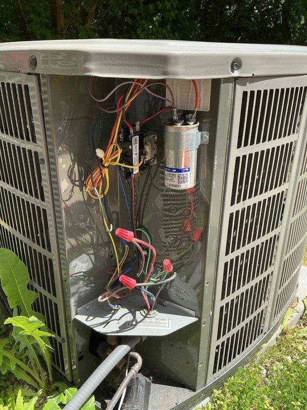 Completed comprehensive clean and check maintenance on two air conditioning systems per Comfort Plan agreement. Performed thorough inspection of outdoor condenser units, including removal of access panels to evaluate electrical components, capacitors, contactors, and wiring connections. Measured amp draw and voltage readings using digital clamp meter to verify proper system operation, with readings showing 149.1 volts and 0.037 amps on tested circuits. All electrical connections were inspected for integrity, wire terminals were secure, and capacitor condition was verified. Systems are operating within manufacturer specifications and ready for the cooling season.
