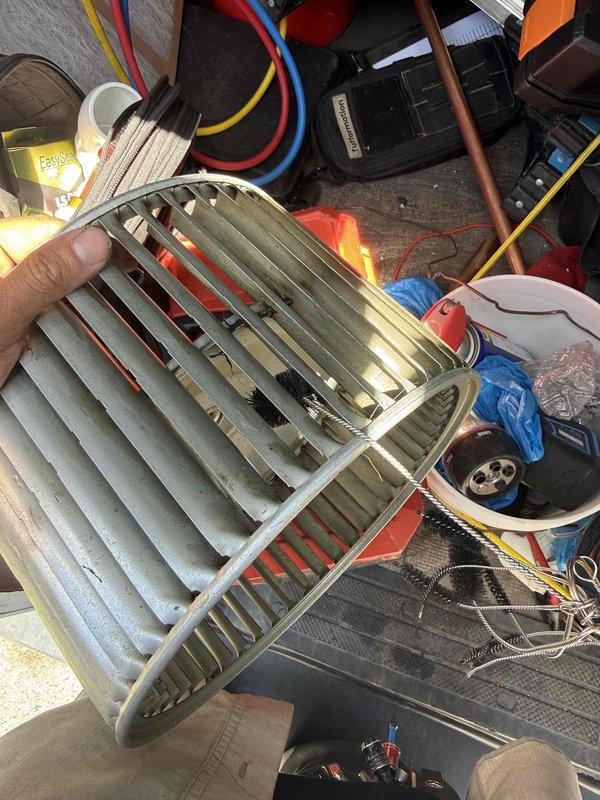 Performed blower wheel cleaning service on HVAC system. Removed and thoroughly cleaned the squirrel cage blower wheel assembly, which showed significant dust and debris accumulation on the blades and between the fins. Also cleaned the evaporator coil assembly, removing dirt and grime buildup from the aluminum fins and metallic surfaces to restore proper airflow and system efficiency.