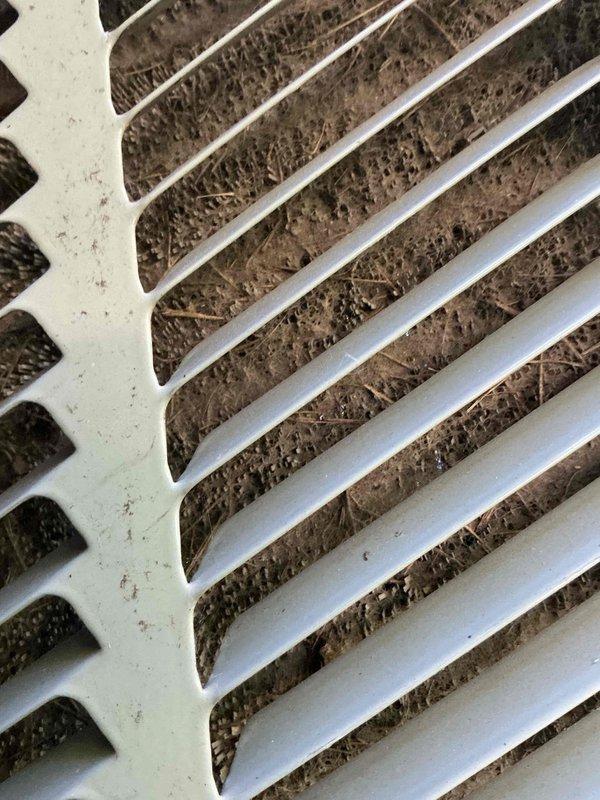 Responded to service call for air conditioning unit making unusual noises and not operating. Upon arrival, performed diagnostic inspection of the system. Found heavily soiled air filter with significant dust and debris accumulation, restricting airflow to the unit. Return air vent grille also showed substantial buildup of dust, lint, and particulate matter between slats. Replaced dirty air filter with new filter to restore proper airflow. Cleaned return air vent cover to remove debris accumulation. Cycled system to verify proper operation and confirm noise issue was resolved due to restricted airflow condition. Unit now operating normally with adequate airflow and no abnormal sounds. Documented equipment information and discussed preventative maintenance options with customer including regular filter replacement schedule.