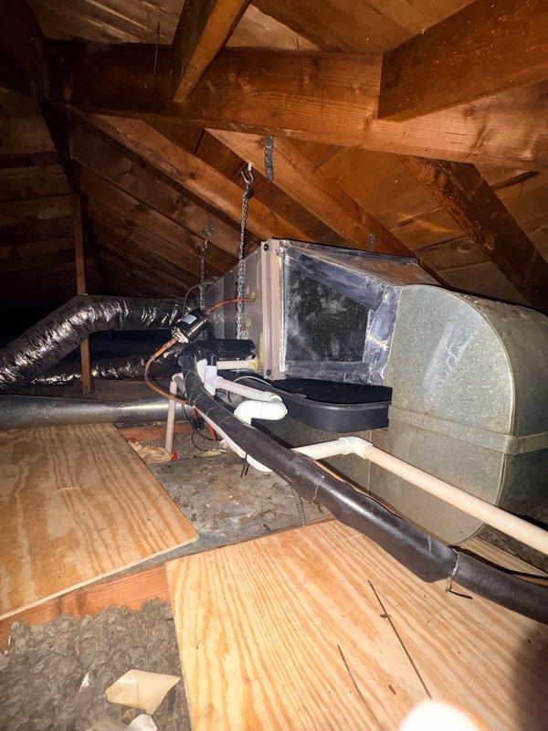 Responded to warranty call for HVAC system less than 10 months old experiencing low refrigerant pressure and inadequate delta temperature readings. Diagnosed low-side PSI deficiency and added 1.75 lbs of R454B refrigerant with Easy Seal, but system performance did not improve. Determined that complete refrigerant recovery, system weighing, line flushing, and full recharge will be required to resolve the issue. Documented attic-mounted air handler unit installation and associated ductwork configuration for follow-up service.