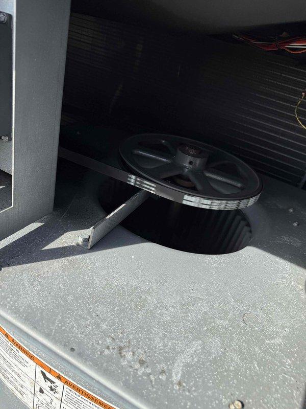 Responded to commercial service call for rooftop unit belt replacement. Upon arrival, accessed RTU and inspected belt drive system. Found worn belt on blower motor pulley requiring replacement. Removed access panels to reach pulley assembly and disconnected failed belt from motor and blower pulleys. Installed new V-belt with proper tension and alignment on drive system. Verified belt tracking and pulley alignment to ensure optimal performance. Tested unit operation to confirm proper belt function and motor operation. Secured all access panels and left unit running normally.