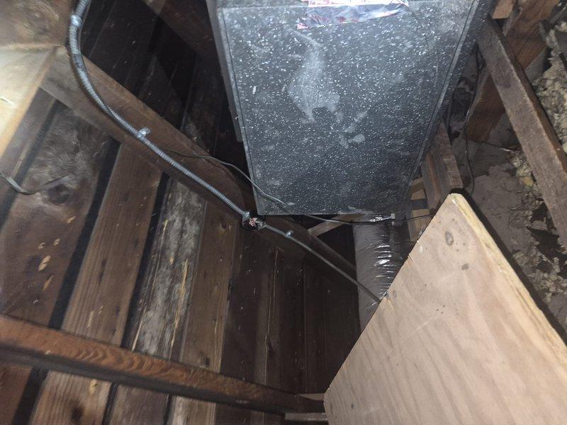 Responded to no cooling call and performed diagnostic evaluation of air conditioning system. Upon inspection, discovered excessive condensation on supply plenum in attic space, indicating potential airflow restriction or low refrigerant charge. Used digital multimeter to verify electrical readings and system operation. Documented equipment conditions with photos showing heavy moisture accumulation on ductwork, suggesting system running continuously with inadequate cooling capacity.