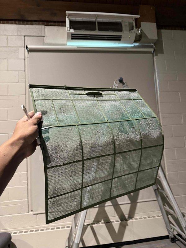 Performed comprehensive preventive maintenance on five wall-mounted ductless mini-split air conditioning units located in the sanctuary according to commercial customer program specifications. Removed and inspected air filters from all units, which exhibited heavy accumulation of dust, debris, and particulate matter requiring thorough cleaning. Cleaned filter assemblies, inspected internal components with front covers open, verified proper operation of LED indicators, and reassured all units were functioning within normal parameters before reinstallation of filters and closure of access panels.