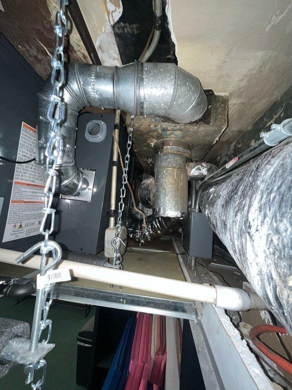 Completed commercial HVAC system replacement involving removal and installation of horizontal furnace and evaporator coil assembly in ceiling-mounted configuration. Replaced existing Bryant horizontal furnace unit positioned adjacent to previously serviced coil near entry hallway. Installed new evaporator coil to match existing 3.5-ton rooftop air conditioning condenser unit. 

Performed complete refrigerant evacuation and charging procedures on rooftop condenser, verifying system pressures and temperatures using manifold gauges. Achieved proper vacuum levels during evacuation process to ensure system integrity and moisture removal. Connected refrigerant lines between new indoor coil and existing rooftop condensing unit, pressure-tested all connections for leaks.

Configured ductwork connections to new horizontal furnace in confined ceiling space, ensuring proper airflow distribution. Verified all electrical connections, tested safety controls, and confirmed proper operation of blower 