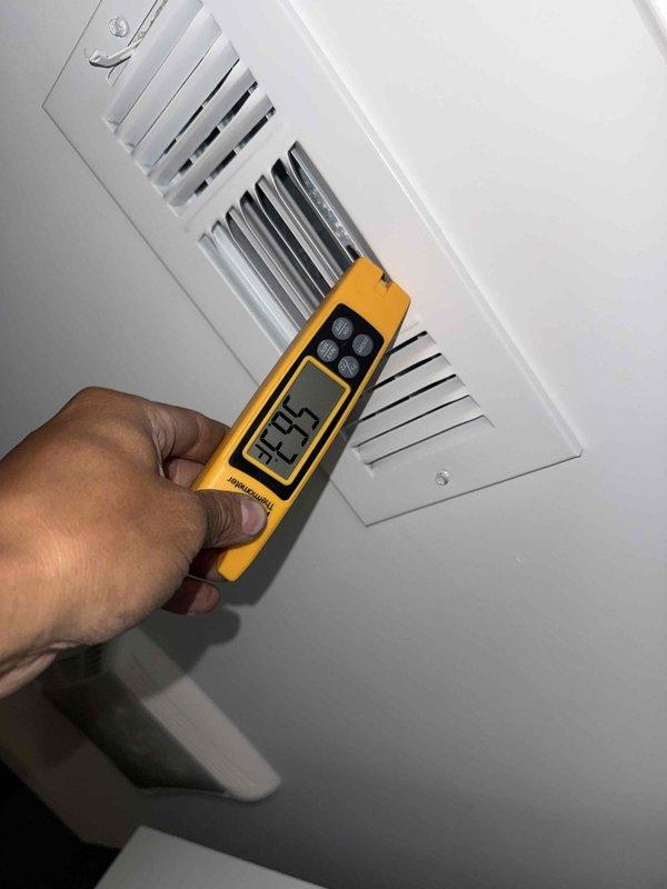 # HVAC Tune-Up Completed

Performed comprehensive air conditioning tune-up on residential single-system unit. Conducted supply air temperature measurements at ceiling register using calibrated digital meter to verify proper system operation and temperature differential. Inspected interior air handler components including condensate drain line, evaporator coil access area, and internal cabinet condition. Noted moderate dust accumulation on metallic surfaces and condensate drainage system requiring routine monitoring. System operating within normal parameters with adequate airflow delivery through supply vents.
