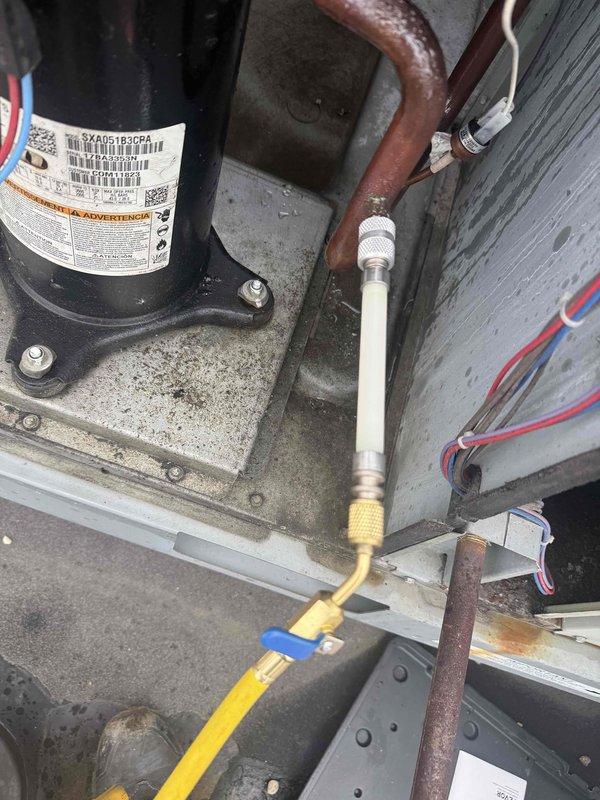Responded to callback for rooftop unit experiencing loud noise that persisted after previous service visit in May. Performed diagnostic inspection of compressor and refrigerant system, utilizing manifold gauges to check system pressures and infrared thermometer to measure supply air temperature at ceiling diffuser. Collected labor time for warranty evaluation and further diagnosis of recurring noise issue.