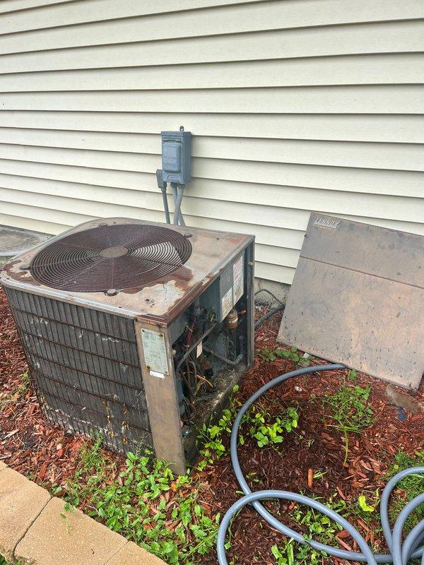 Conducted on-site evaluation of a non-functional 20-year-old HVAC system original to the home. Assessed both indoor furnace unit located in basement mechanical room and outdoor air conditioning condenser, which exhibited severe rust, corrosion, and deterioration throughout metal casing and components. Documented equipment condition, reviewed system specifications, and provided comprehensive replacement estimate for complete HVAC system upgrade.