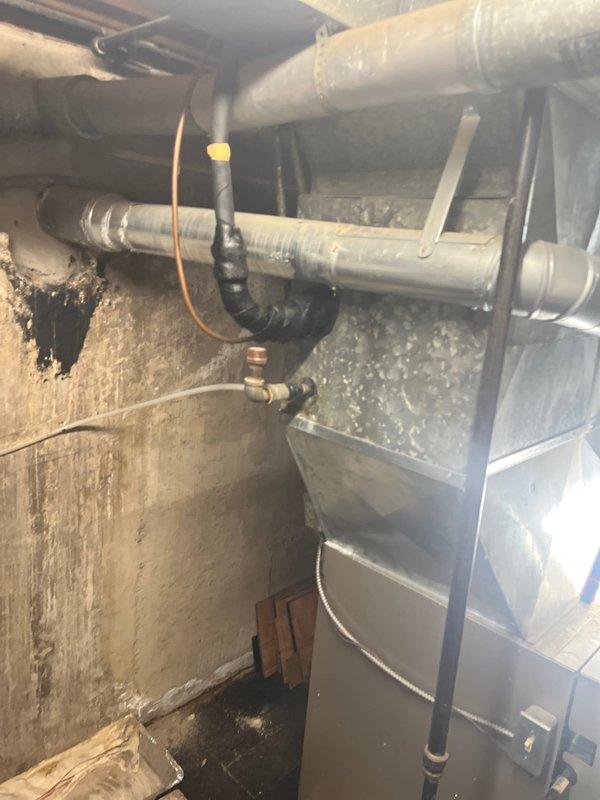 Responded to service call for non-operational air conditioning system with outdoor fan not rotating. Upon inspection, found aging HVAC equipment dating from 2007 showing significant deterioration and wear on exterior components. Conducted comprehensive system evaluation of both cooling and heating equipment in basement mechanical space, documenting existing ductwork configuration and equipment dimensions. Based on age of system, extent of component degradation, and failed condenser fan motor, provided complete HVAC system replacement estimate as most cost-effective long-term solution versus repair of aging equipment.