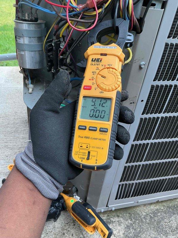 Completed comprehensive clean and check maintenance service on residential air conditioning system and Air Scrubber unit. Performed electrical diagnostics using digital multimeter to verify proper voltage and amperage readings on system components, confirming capacitor functionality and overall electrical performance within manufacturer specifications. All components inspected and found operating normally with no deficiencies noted.