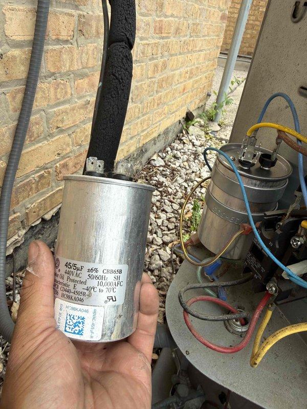 Responded to no cooling complaint with tripped breaker, a recurring issue previously documented. Upon arrival, confirmed AC system was non-operational with breaker tripped at panel. Conducted comprehensive diagnostic of outdoor condensing unit and indoor air handler system. Verified evaporator and condenser coils were clean with no airflow restrictions. Performed electrical diagnostics including amp draw testing on condenser fan motor, contactor voltage verification, and circuit breaker integrity assessment. Measured operating amperage on compressor and fan motor circuits to identify potential electrical fault causing breaker trips. Inspected contactor for pitting, proper voltage pull-in, and contact integrity. Evaluated circuit breaker for signs of degradation or failure that could cause nuisance tripping. Replaced failed dual-run capacitor (45/5 MFD, 370VAC) which tested outside acceptable tolerance range and showed signs of deterioration. Capacitor failure was contributing to elevat