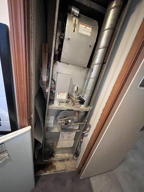 Responded to no cooling complaint at mobile home residence. Upon arrival, found R-410A refrigerant system with vertically-stacked HVAC equipment in utility closet. Performed diagnostic evaluation of air conditioning system, verified thermostat settings, checked electrical connections and breakers, and inspected air filter condition. Documented equipment information and photographed existing installation configuration for service records.