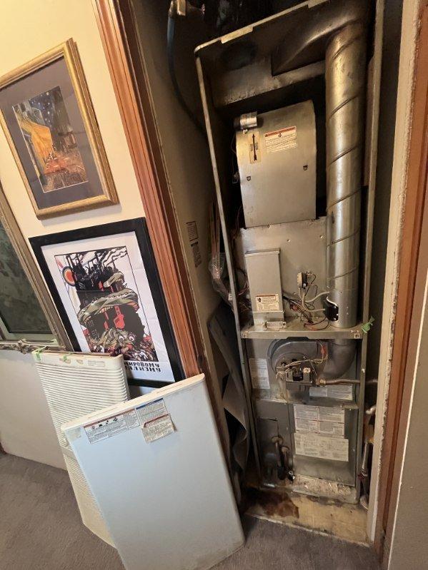 Responded to no cooling complaint at mobile home residence. Upon arrival, found R-410A refrigerant system with vertically-stacked HVAC equipment in utility closet. Performed diagnostic evaluation of air conditioning system, verified thermostat settings, checked electrical connections and breakers, and inspected air filter condition. Documented equipment information and photographed existing installation configuration for service records.