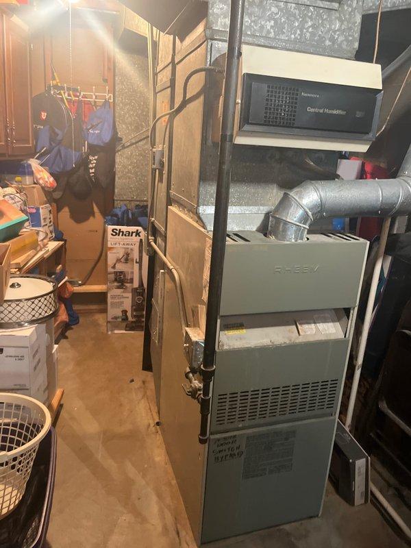 Conducted comprehensive assessment of 20+ year old Bryant air conditioning system for replacement estimate. Evaluated outdoor condensing unit showing significant age-related wear and deterioration, along with indoor furnace and air handler components in basement utility area. Provided detailed replacement options and recommendations for complete HVAC system upgrade due to equipment age exceeding expected service life.