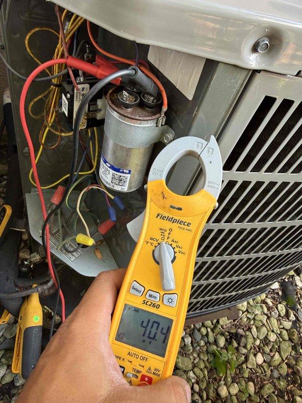 Completed annual air conditioning clean and check maintenance per Comfort Plan agreement. Performed comprehensive system inspection including electrical measurements with clamp meter, verifying amperage readings of 40.3A and 23.9A at various points in the system. Inspected capacitor, wiring connections, and condenser coil condition. All components operating within normal parameters and system functioning properly.
