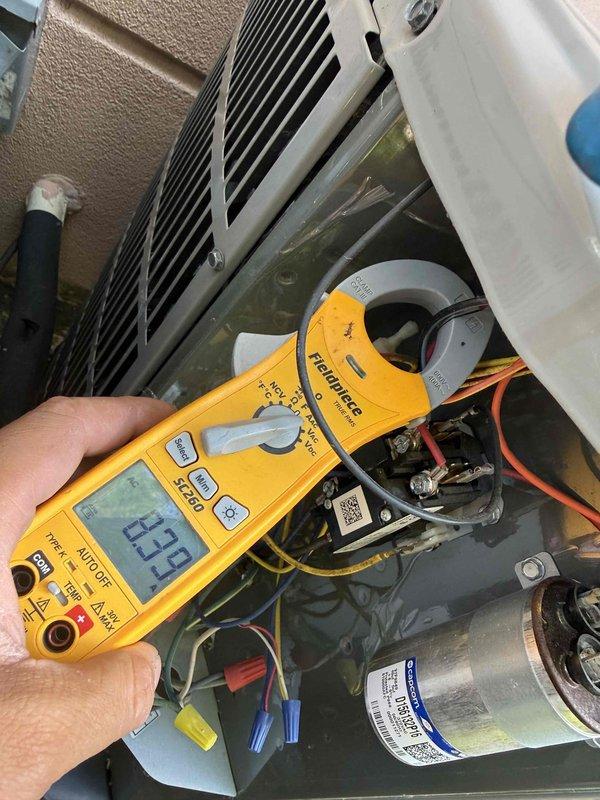 Completed annual air conditioning clean and check maintenance per Comfort Plan agreement. Performed comprehensive system inspection including electrical measurements with clamp meter, verifying amperage readings of 40.3A and 23.9A at various points in the system. Inspected capacitor, wiring connections, and condenser coil condition. All components operating within normal parameters and system functioning properly.
