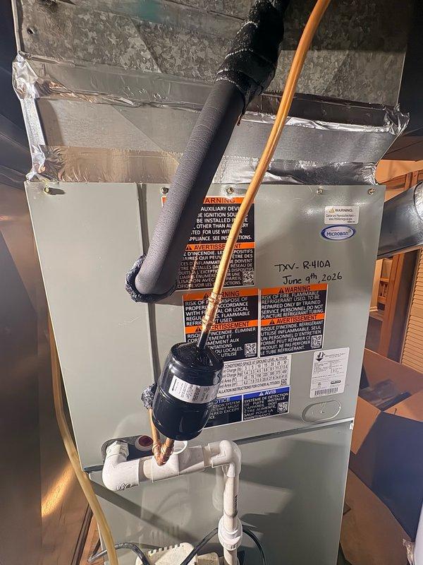 Returned to site to diagnose refrigerant leak location on R-410A system. Inspected air handler unit and determined leak was originating from the evaporator coil rather than the TXV or piston metering device. Replaced defective evaporator coil under manufacturer warranty, evacuated system, and recharged with proper refrigerant specification. Verified system operation and confirmed no additional leaks present.