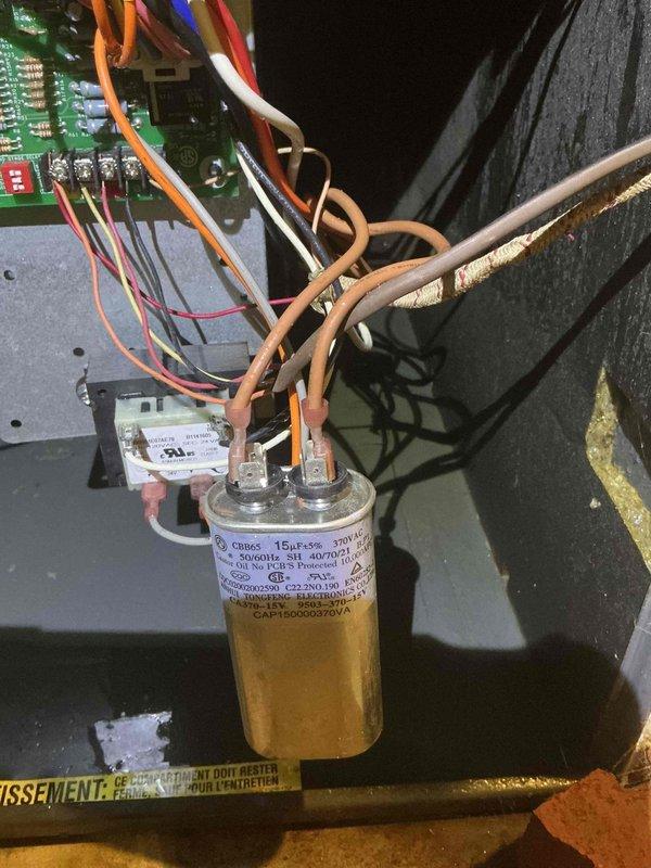 Responded to no cooling call on 20+ year old air conditioning system. Upon arrival, performed diagnostic evaluation of unit operation and electrical components. Tested capacitor functionality and measured voltage readings at control board connections. Capacitor showed degraded performance with readings of 61.1 microfarads, indicating failure below manufacturer specifications. Inspected wiring connections at circuit board and capacitor terminals, noting multiple wire connections showing signs of age and heat stress. Documented equipment condition with photos of failed capacitor assembly and diagnostic meter readings. Explained findings to customer regarding failed capacitor preventing compressor operation and discussed repair options for aging system. Provided recommendations for immediate repair to restore cooling function and advised on long-term equipment replacement considerations given the advanced age of the unit.