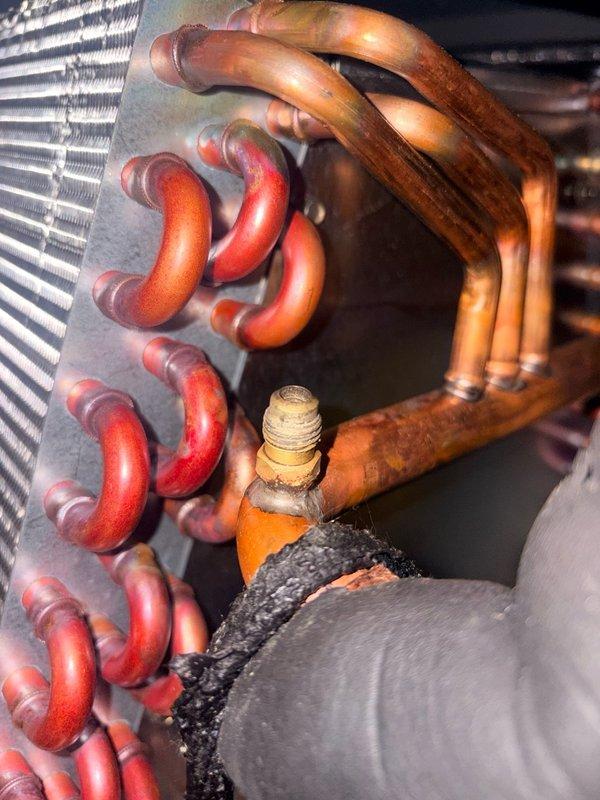 Replaced defective circuit board on Rinnai unit and restored system to proper operation. Collected outstanding invoice balance and documented the completed repair with photographs of the internal components including copper refrigerant lines, heat exchanger coils, and brass fittings.