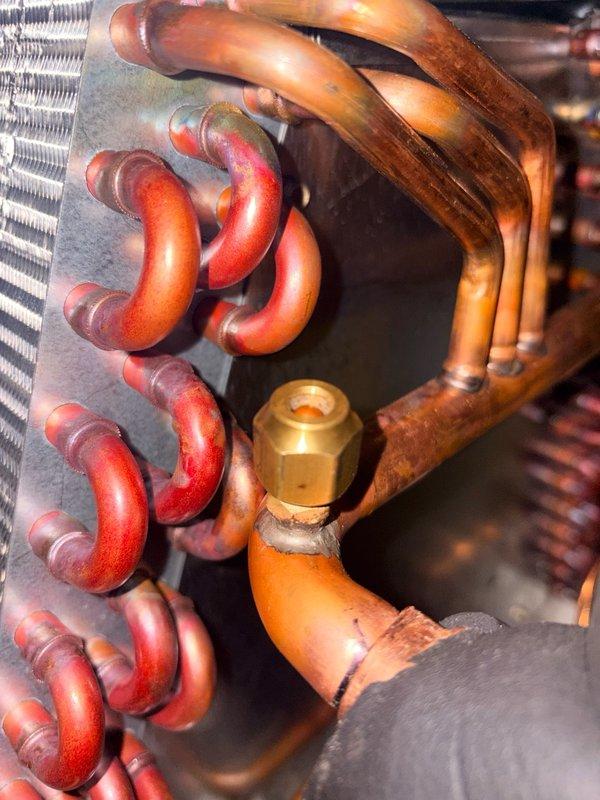 Replaced defective circuit board on Rinnai unit and restored system to proper operation. Collected outstanding invoice balance and documented the completed repair with photographs of the internal components including copper refrigerant lines, heat exchanger coils, and brass fittings.