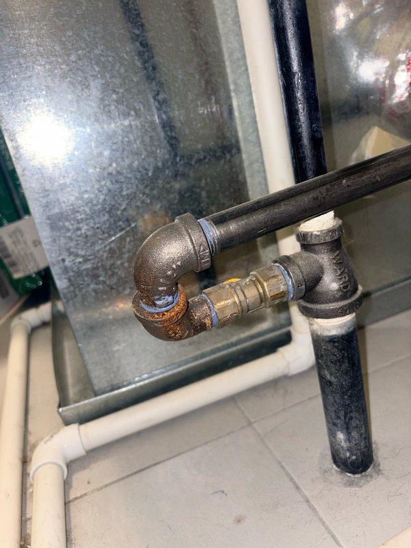 Completed repiping work by replacing existing 1/2" black iron pipe with 3/4" black iron pipe to improve gas flow capacity. Removed corroded sections showing visible rust at elbow joints and compression fittings. Installed new 3/4" black pipe with proper fittings and connections near HVAC ductwork in utility area. All connections were properly sealed and tested for leaks. System restored to full operational status.