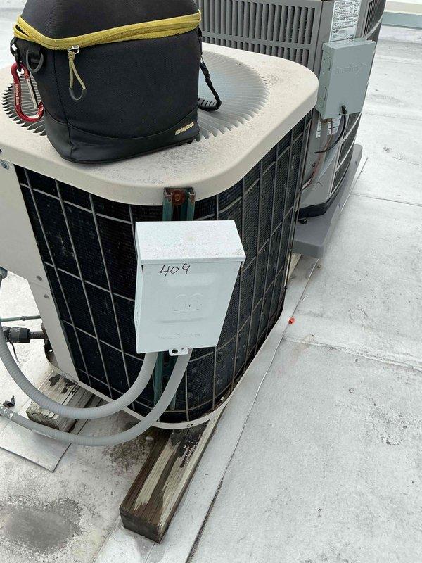 Completed Comfort Plan clean and check service on rooftop HVAC system. Performed comprehensive inspection of condenser unit, verified electrical connections at disconnect box, and inspected internal components including TITAN PRO capacitor and contactor assembly. All components found operating within normal parameters, connections secure, and system functioning properly.