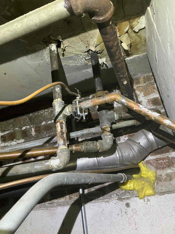 Completed preventative maintenance tune-up on single-system HVAC unit with Airtemp furnace. Performed standard inspection of heating equipment, verified proper venting configuration of PVC intake and exhaust pipes, and checked all mechanical components for operational efficiency. System found to be in normal working condition with age-appropriate wear on copper piping and plumbing connections showing expected oxidation.