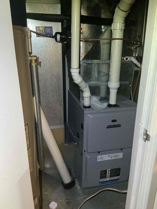 Completed preventative maintenance tune-up on single-system HVAC unit with Airtemp furnace. Performed standard inspection of heating equipment, verified proper venting configuration of PVC intake and exhaust pipes, and checked all mechanical components for operational efficiency. System found to be in normal working condition with age-appropriate wear on copper piping and plumbing connections showing expected oxidation.
