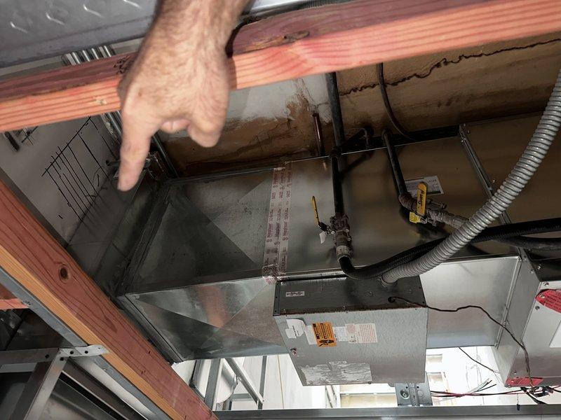 Completed comprehensive ductwork modifications for commercial HVAC system including removal of existing ceiling duct from front entry bathroom with trunk line patching, installation of new supply duct in heat pump closet utilizing flatway 90-degree elbow for proper wall discharge, and addition of 6x10 exhaust register above toilet in entry bathroom. Relocated 4x12 ductwork from removed bathroom section to create new 6x10 return air pathway in master bathroom using two shortway 90-degree elbows, routing through stud space adjacent to existing return. Installed additional 6x10 return air duct in laundry room by running wall stack through stud cavities, connecting to master bathroom return plenum to improve overall system air balance and circulation.