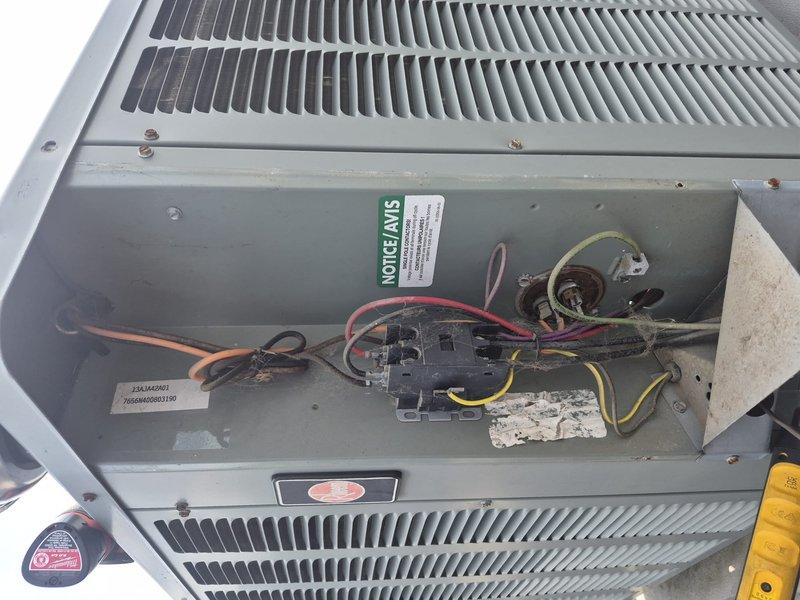 Completed annual air conditioning maintenance on rooftop unit at new commercial building requiring 40-foot ladder access to flat roof approximately 30 feet high. Performed comprehensive tune-up inspection including electrical component testing with clamp meter showing 33-amp draw, verified contactor and capacitor operation, inspected condenser coil condition, documented all equipment specifications and serial numbers, and captured detailed photographs of system components and electrical connections. Discussed comfort program benefits with property representative and collected all necessary equipment information for service records.