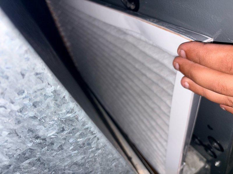 Responded to no cooling complaint on 18-19 year old residential AC system. Upon inspection, discovered extensive ice buildup on evaporator coil and interior air handler surfaces, indicating restricted airflow or low refrigerant charge. Documented frozen coil condition with photographs showing heavy frost accumulation on coil fins and surrounding components. Verified thermostat settings, checked air filter condition, and confirmed breaker status. System unable to provide adequate cooling due to icing condition preventing proper heat exchange. Recommended allowing unit to thaw completely before further diagnostics to determine root cause—either refrigerant leak requiring recharge or airflow restriction from dirty coil/blower issues. Given age of equipment, discussed system replacement options as alternative to repairs on aging unit approaching end of expected service life.