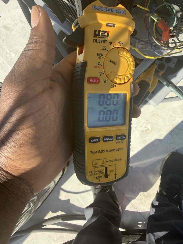 Responded to no cooling call and performed diagnostic evaluation of residential air conditioning system. Upon arrival, utilized digital clamp meter to test electrical components and verify system operation. Measured amperage draws and voltage readings at outdoor condensing unit to assess compressor and fan motor performance. Documented equipment nameplate information and captured diagnostic readings for service records. Discussed findings with customer and presented repair options to restore cooling operation.