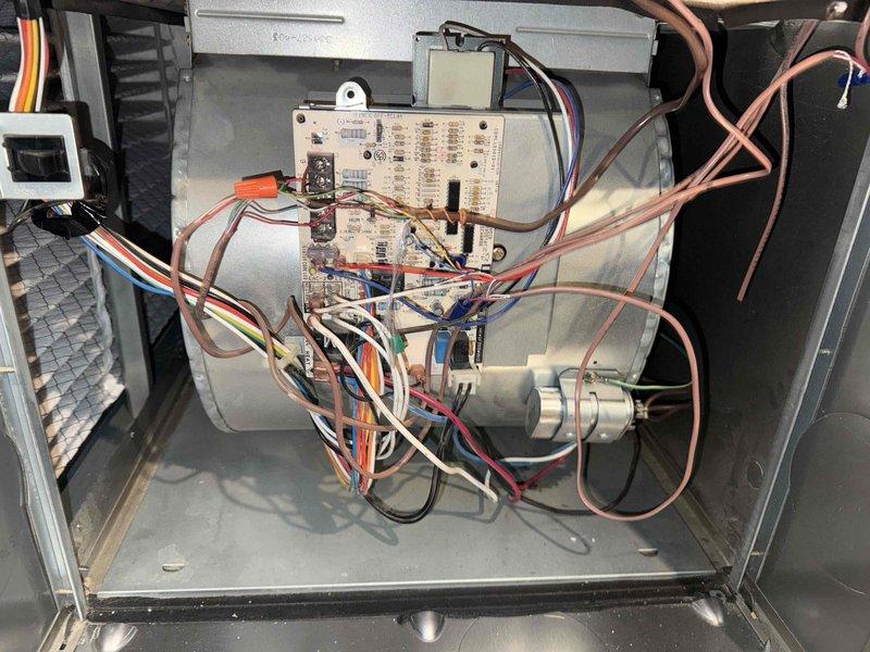 Completed annual air conditioning clean and check maintenance per Comfort Plan agreement. Performed comprehensive system inspection including blower motor assembly, control board operation, and electrical connections. Verified amperage readings at 82.1 amps using clamp meter, confirmed all electrical components functioning within normal parameters, and documented system condition with interior component photography.