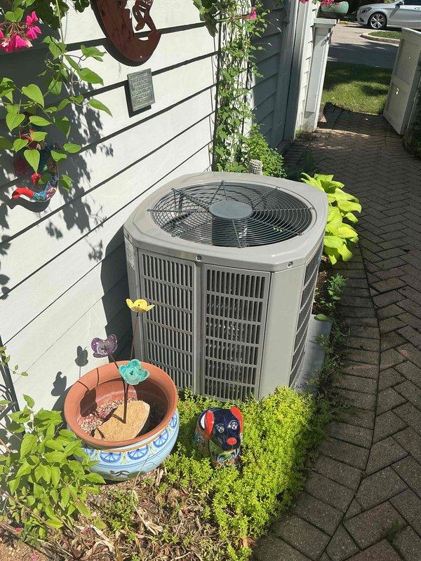 Completed spring maintenance and clean and check service on residential air conditioning system per Comfort Plan agreement. Performed comprehensive system inspection of outdoor condenser unit, verified electrical readings showing 297.2 volts and 60.0 Hz frequency within normal operating parameters, and confirmed unit operational status at 400.0 amp reading. System operating properly with no deficiencies noted at time of service.