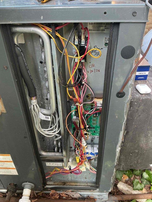 Responded to callback for HVAC unit experiencing intermittent cycling issues following previous service visit. Upon arrival, accessed unit interior to inspect electrical connections, control board, and wiring harness for loose connections or failed components that could cause equipment to short cycle. Photographed internal components including circuit board, refrigerant lines, and electrical connections for documentation. Exterior inspection revealed unit positioned in area with vegetation growth and debris accumulation around base that may impact airflow and operation. Continuation of diagnostic work from previous service call to identify root cause of recurring on/off cycling problem.