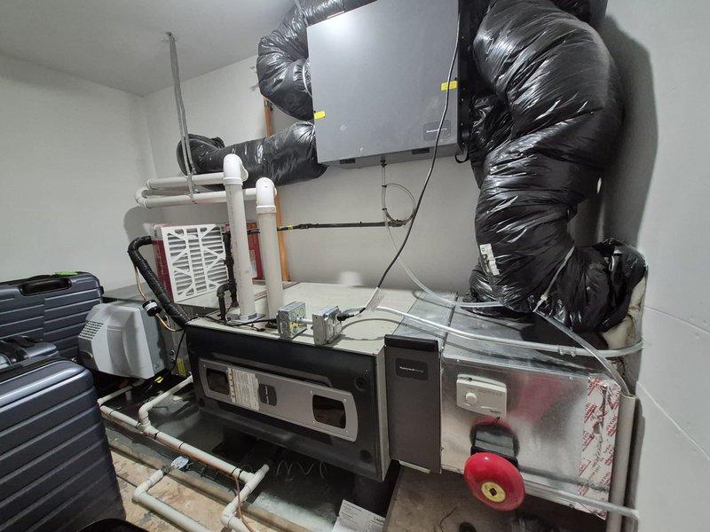 # HVAC Maintenance Summary

Completed comprehensive spring clean and check maintenance service on a two-system HVAC installation per Good Comfort Plan protocol. Performed thorough inspection of wall-mounted air handler and base unit, including electrical component testing of capacitor and relay switches, verification of all wire connections, and assessment of condensate drainage system. All systems operational and functioning within normal parameters.

# Detailed Service Description

Performed seasonal preventive maintenance on dual HVAC system installation located in mechanical utility room. Conducted complete visual inspection of wall-mounted gray cabinet air handler unit and corresponding base equipment with integrated ductwork system.

Accessed electrical compartment to inspect internal components including dual-run capacitor, relay switches, and associated wiring harness. Verified all electrical connections were secure with proper terminations on capacitor terminals and relay cont