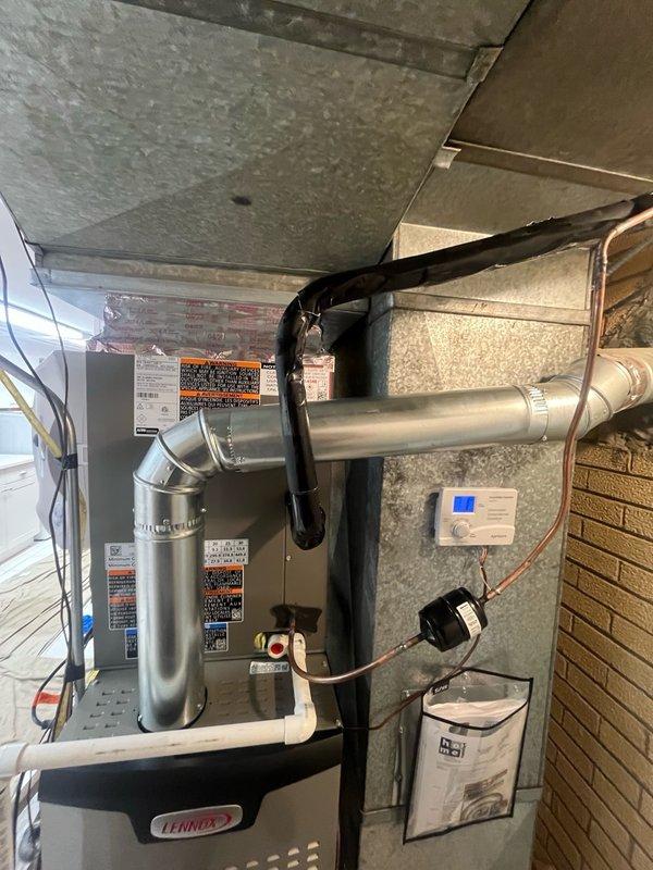 Completed full HVAC system replacement including removal and disposal of existing forced air furnace and air conditioning system. Installed new Lennox 88K BTU 80% efficiency two-stage variable speed furnace (Model EL280UH090E36BK) with connections to existing supply and return ductwork, gas line, electrical circuit, and exhaust system. Reclaimed refrigerant from old AC system and installed new Lennox 3-ton 18 SEER2 variable speed condensing unit (Model EL18KCV-036-230) on leveled pad with pea gravel, along with new evaporator coil. Connected system to existing copper refrigerant lines, evacuated system, and charged with R454B refrigerant. Installed new Honeywell Home programmable thermostat, whole-house humidifier, and surge protector. Performed complete system startup, testing, adjustment, and safety inspection to verify proper operation of all equipment. System includes 12-year parts warranty and 12-year extended labor agreement.