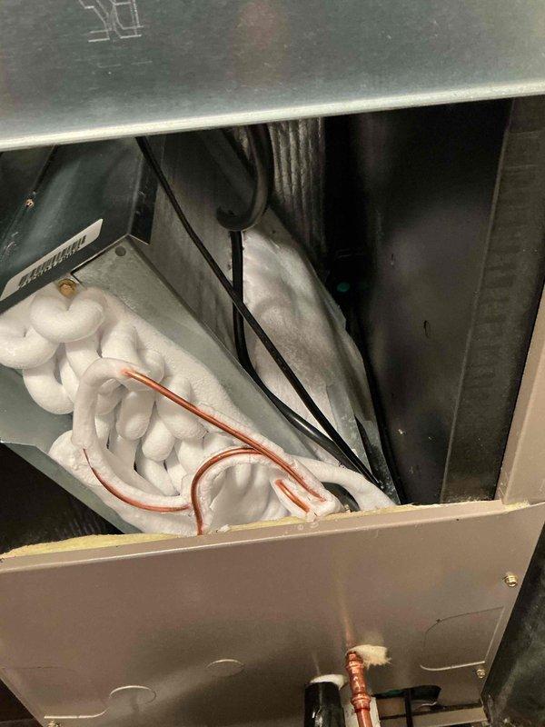 Responded to no cooling complaint on recently installed HVAC system. Upon arrival, performed diagnostic inspection of air handler and associated components. Verified proper installation of copper refrigerant lines and electrical connections within insulated air handler cabinet. Checked system airflow and filter placement. Inspected condensate drain routing and plumbing connections. Documented equipment condition with photos showing internal components and proper insulation installation. System evaluated for installation-related issues. Customer advised of findings.
