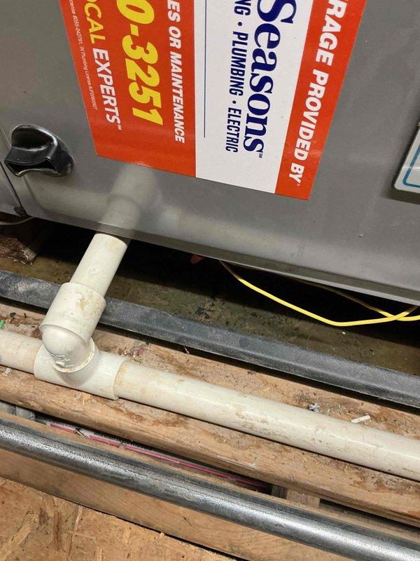 Responded to service call for AC not cooling evenly with water accumulation in safety drain pan. Upon arrival, inspected HVAC system installation including condensate drainage components and ductwork routing throughout attic space. Documented existing system configuration showing PVC condensate drain line with visible staining and discoloration, copper refrigerant lines, and flexible aluminum ductwork distribution system. Collected equipment information for new customer account and photographed installation for service records.
