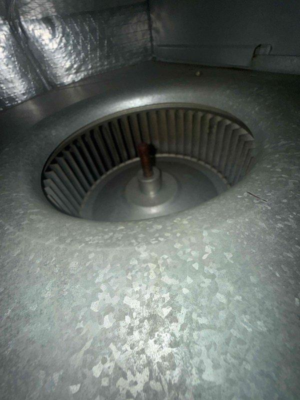 Responded to service call for inadequate cooling and unusual operating noise from attic-mounted air handler. Upon inspection, found blower wheel heavily contaminated with dust and debris buildup, causing restricted airflow and abnormal sound during operation. Cleaned blower assembly, removed accumulated debris from cabinet interior, and verified proper electrical connections and control wiring. System tested and confirmed restored airflow and normal operation with no abnormal noise. Discussed preventive maintenance options and documented equipment information for service records.