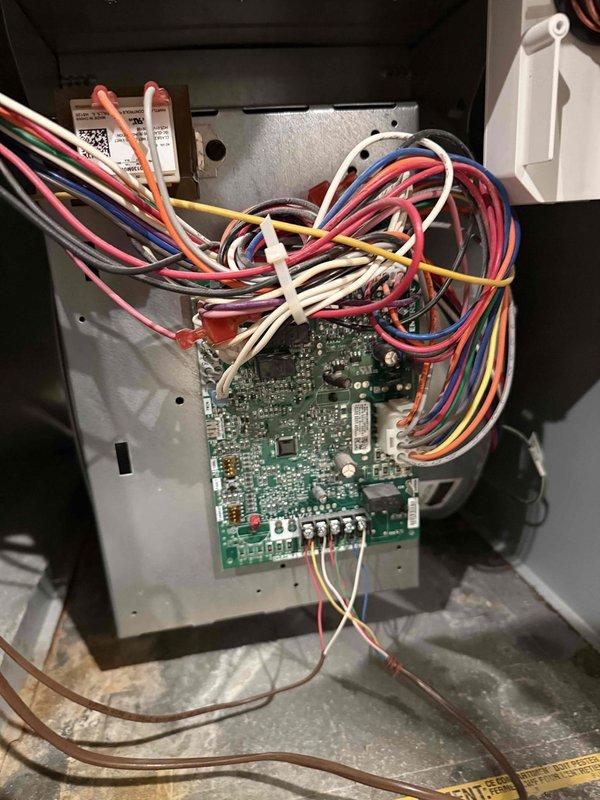 Completed Silver Comfort Plan clean and check service on Goodman HVAC system for new customer. Performed comprehensive inspection of furnace and air conditioning unit, documented all equipment information and model numbers, inspected control board and low-voltage wiring connections within control panel, and verified proper operation of all system components. Captured detailed photos of control board assembly and overall equipment installation for service records.