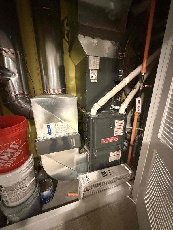 Completed Silver Comfort Plan clean and check service on Goodman HVAC system for new customer. Performed comprehensive inspection of furnace and air conditioning unit, documented all equipment information and model numbers, inspected control board and low-voltage wiring connections within control panel, and verified proper operation of all system components. Captured detailed photos of control board assembly and overall equipment installation for service records.