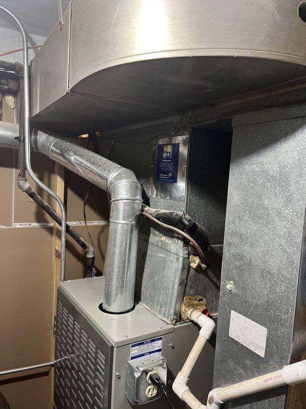 Responded to service call for air conditioning system not cooling efficiently. Performed diagnostic evaluation of existing HVAC system including furnace and air handler unit located in basement utility area. Assessed overall system condition, refrigerant lines, ductwork connections, and equipment configuration. Documented existing equipment information and installation setup including condensate drainage lines and electrical connections for estimate preparation.
