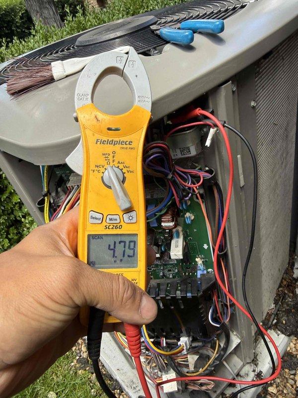 Responded to no cooling complaint on air conditioning system installed in 2023 under warranty. Performed diagnostic evaluation and measured electrical parameters at outdoor unit, recording amperage draw of 47.9 amps using clamp meter. Inspected internal electrical components, wiring connections, and circuit board. Evaluated heavily soiled air filter showing significant dust and debris accumulation restricting airflow. Presented comfort plan options for annual maintenance coverage on both air conditioning and heating equipment.