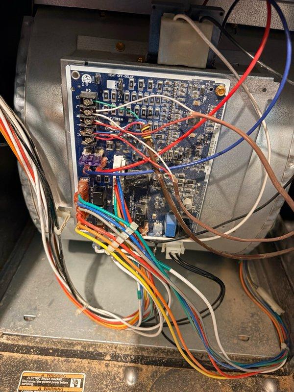 Replaced failed OEM electronic control board on HVAC system. Removed defective circuit board from blower housing, installed new OEM replacement control board (model ECAY 07 35JBY), and reconnected all wiring harnesses including power, control, and safety circuits to restore proper system operation.