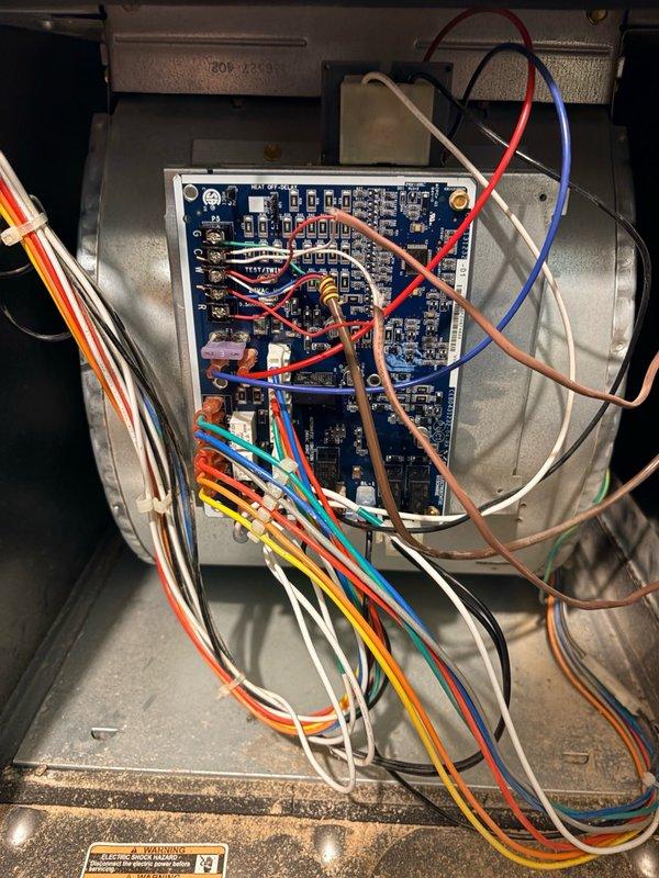 Replaced failed OEM electronic control board on HVAC system. Removed defective circuit board from blower housing, installed new OEM replacement control board (model ECAY 07 35JBY), and reconnected all wiring harnesses including power, control, and safety circuits to restore proper system operation.